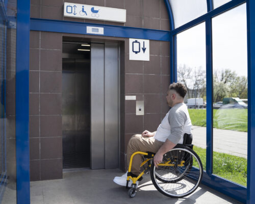 full-shot-disabled-man-taking-elevator